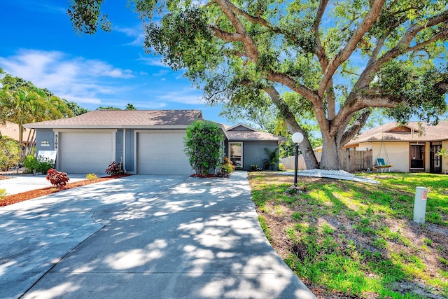 5192 Cedar Hammock Ln, Sarasota, FL 34232 - view of front facade with driveway, a garage, and stucco siding