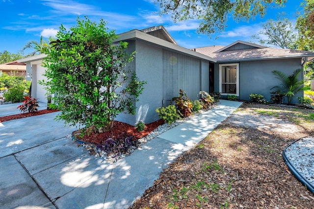 5192 Cedar Hammock Ln, Sarasota, FL 34232 - view of front of house featuring stucco siding and a garage