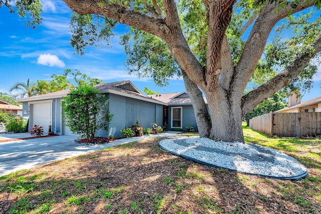 5192 Cedar Hammock Ln, Sarasota, FL 34232 - view of front of property featuring a garage, stucco siding, and driveway