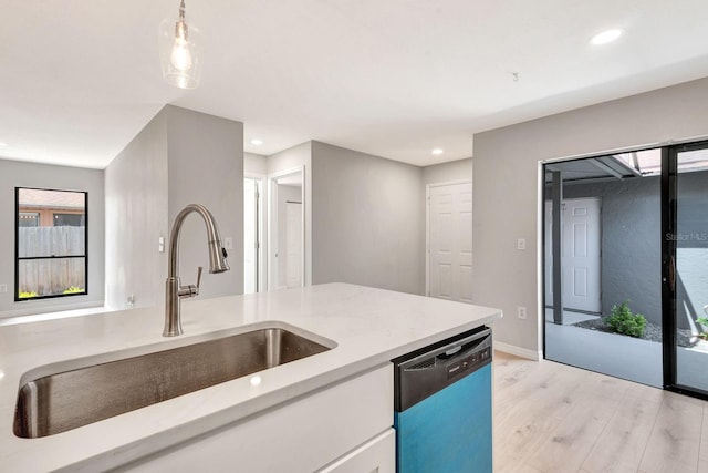 5192 Cedar Hammock Ln, Sarasota, FL 34232 - kitchen with dishwasher, a sink, light wood-style floors, white cabinetry, and recessed lighting