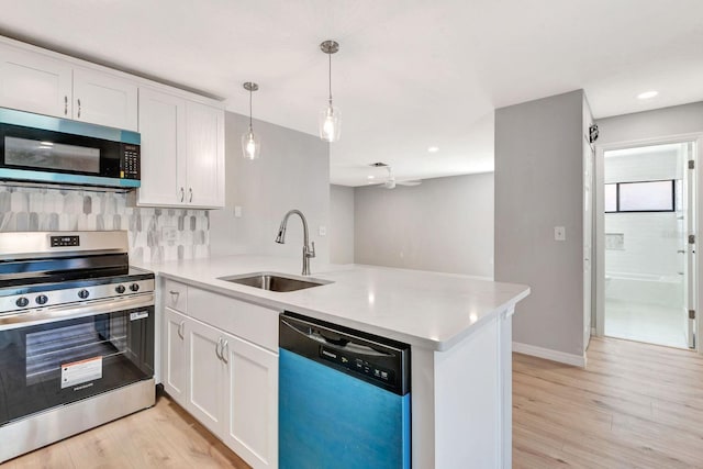 5192 Cedar Hammock Ln, Sarasota, FL 34232 - kitchen featuring stainless steel appliances, a sink, a peninsula, white cabinetry, and light countertops