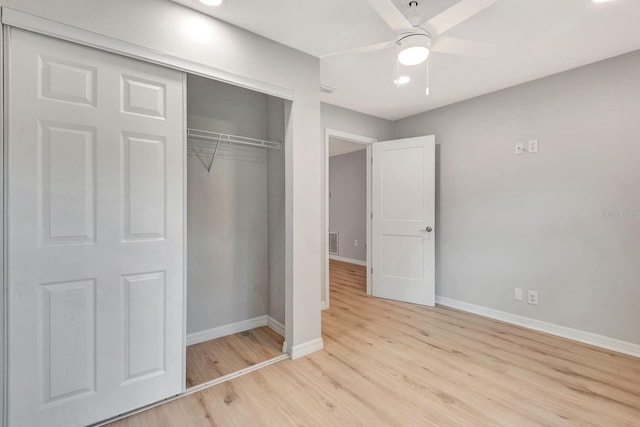 5192 Cedar Hammock Ln, Sarasota, FL 34232 - unfurnished bedroom featuring baseboards, wood finished floors, a closet, and a ceiling fan