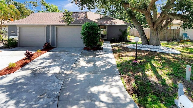 5192 Cedar Hammock Ln, Sarasota, FL 34232 - view of front of house with driveway, roof with shingles, and a garage