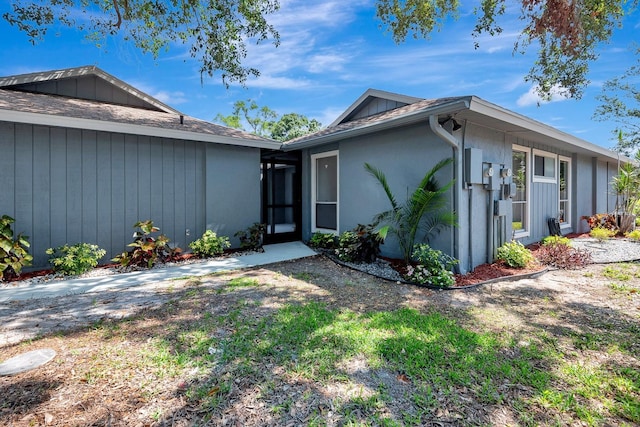 5192 Cedar Hammock Ln, Sarasota, FL 34232 - view of home's exterior with stucco siding and a shingled roof