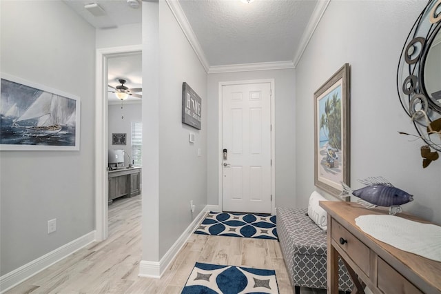 10423 Morning Marsh Ln, Parrish, FL 34219 - entrance foyer featuring light wood-style flooring, a textured ceiling, ornamental molding, baseboards, and a ceiling fan