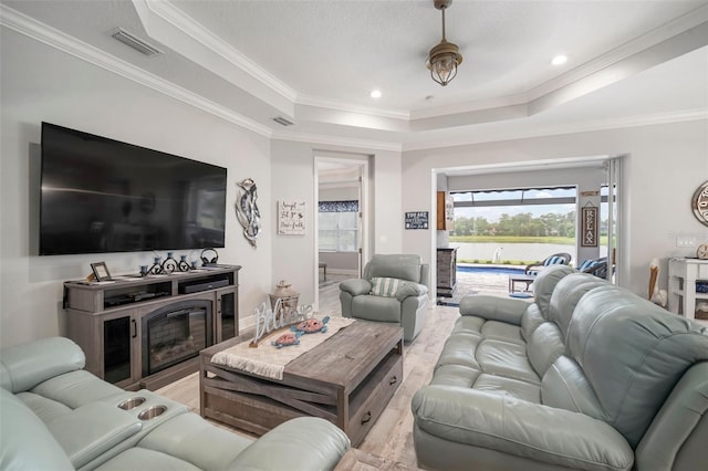 10423 Morning Marsh Ln, Parrish, FL 34219 - living area with a raised ceiling, ornamental molding, wood finished floors, recessed lighting, and a water view