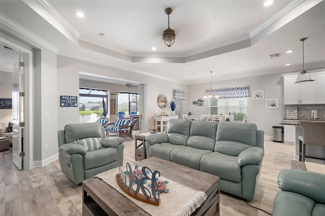 10423 Morning Marsh Ln, Parrish, FL 34219 - living area with a raised ceiling, light wood finished floors, baseboards, recessed lighting, and a chandelier