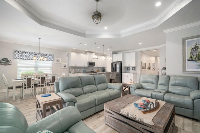 10423 Morning Marsh Ln, Parrish, FL 34219 - living room with a raised ceiling, a chandelier, crown molding, light wood-style flooring, and recessed lighting