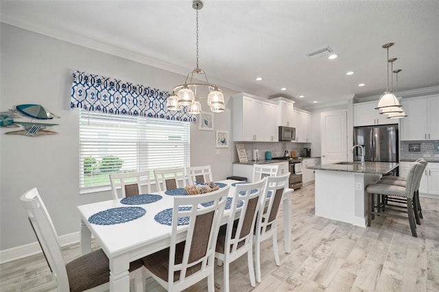10423 Morning Marsh Ln, Parrish, FL 34219 - dining room with crown molding, a chandelier, light wood-style floors, and recessed lighting