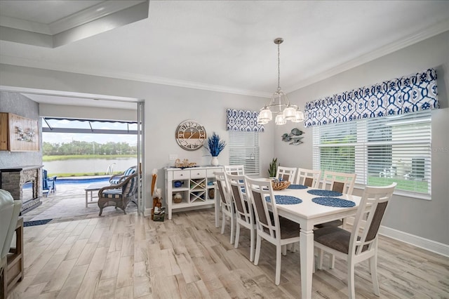 10423 Morning Marsh Ln, Parrish, FL 34219 - dining area with light wood-style floors, a chandelier, a water view, ornamental molding, and baseboards