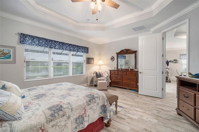 10423 Morning Marsh Ln, Parrish, FL 34219 - bedroom with a tray ceiling, light wood-style floors, ornamental molding, ceiling fan, and baseboards