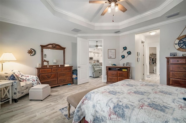 10423 Morning Marsh Ln, Parrish, FL 34219 - bedroom featuring a raised ceiling, wood finished floors, ornamental molding, and a ceiling fan