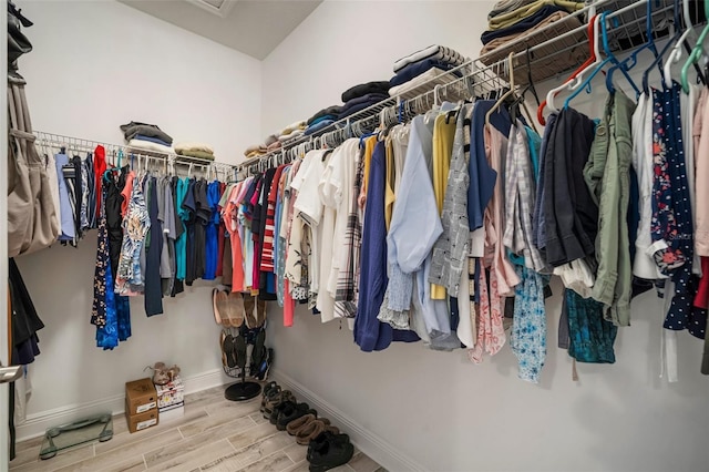 10423 Morning Marsh Ln, Parrish, FL 34219 - walk in closet featuring wood finished floors and attic access