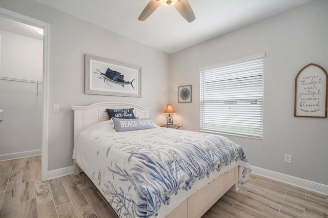 10423 Morning Marsh Ln, Parrish, FL 34219 - bedroom featuring light wood-style flooring, baseboards, and ceiling fan