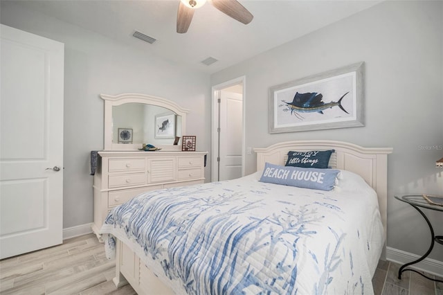 10423 Morning Marsh Ln, Parrish, FL 34219 - bedroom with light wood-style flooring, baseboards, and a ceiling fan