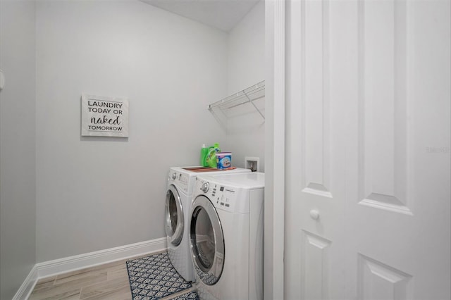 10423 Morning Marsh Ln, Parrish, FL 34219 - laundry area with washer and clothes dryer, baseboards, and light wood finished floors