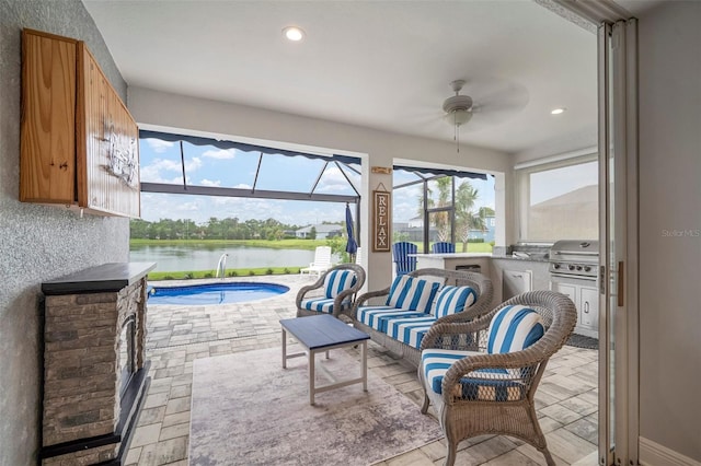 10423 Morning Marsh Ln, Parrish, FL 34219 - sunroom / solarium featuring a ceiling fan, a water view, a swimming pool, and area for grilling
