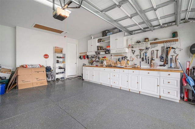 10423 Morning Marsh Ln, Parrish, FL 34219 - garage with a workshop area and a garage door opener