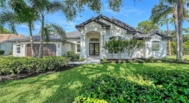 6641 Saint James Xing, University Park, FL 34201 - mediterranean / spanish-style house with stucco siding, an attached garage, a front yard, and french doors
