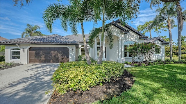 6641 Saint James Xing, University Park, FL 34201 - mediterranean / spanish house featuring an attached garage, a front yard, stucco siding, driveway, and a tiled roof