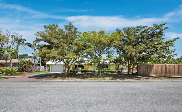 335 Arthur Dr, Sarasota, FL 34236 - obstructed view of property featuring a garage, asphalt driveway, and stucco siding