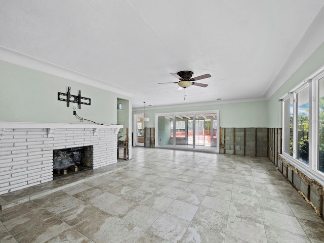 335 Arthur Dr, Sarasota, FL 34236 - unfurnished living room featuring a ceiling fan, healthy amount of natural light, stone tile flooring, and a fireplace