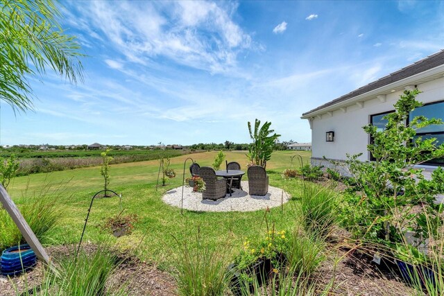 3574 Recurve Cir, Sarasota, FL 34240 - view of green lawn featuring a patio