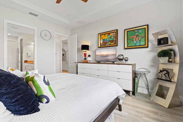 5740 Eagle Creek Rd, Sarasota, FL 34238 - bedroom with light wood finished floors, ensuite bathroom, baseboards, and a ceiling fan