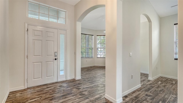 6213 Willet Ct, Lakewood Ranch, FL 34202 - foyer entrance with arched walkways, dark wood-style floors, and baseboards