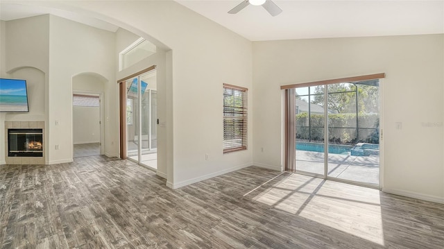 6213 Willet Ct, Lakewood Ranch, FL 34202 - empty room with wood finished floors, plenty of natural light, a ceiling fan, baseboards, and a towering ceiling