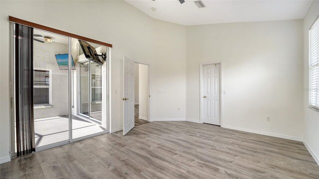 6213 Willet Ct, Lakewood Ranch, FL 34202 - spare room with wood finished floors, baseboards, ceiling fan, and a high ceiling