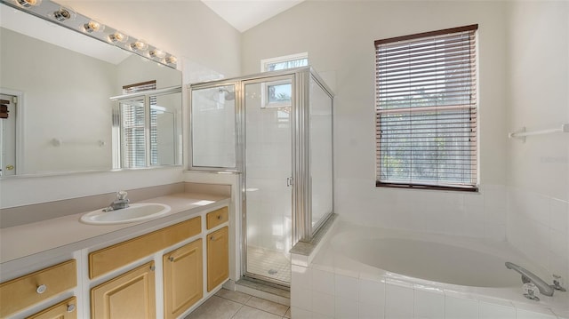 6213 Willet Ct, Lakewood Ranch, FL 34202 - bathroom with a bath, vanity, a shower stall, vaulted ceiling, and tile patterned floors