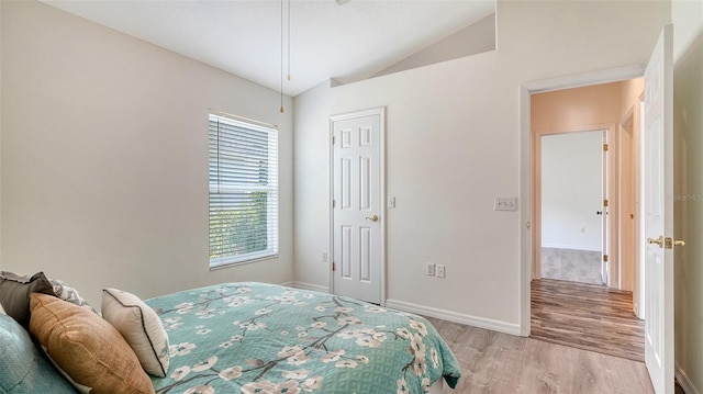 6213 Willet Ct, Lakewood Ranch, FL 34202 - bedroom with light wood-style floors, lofted ceiling, and baseboards