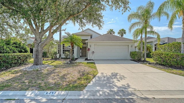 6213 Willet Ct, Lakewood Ranch, FL 34202 - ranch-style house featuring stucco siding, a garage, and driveway