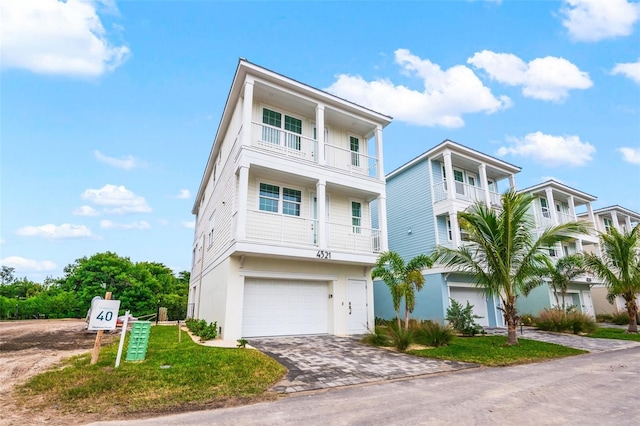 4321 Marina View Way, Cortez, FL 34215 - view of front facade featuring driveway, a balcony, a garage, and stucco siding