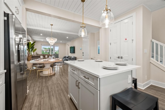 4321 Marina View Way, Cortez, FL 34215 - kitchen featuring stainless steel fridge with ice dispenser, wooden ceiling with exposed beams, dark wood finished floors, light countertops, and open floor plan