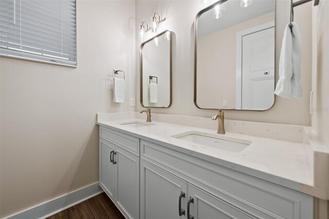 4321 Marina View Way, Cortez, FL 34215 - bathroom featuring double vanity, wood finished floors, and baseboards
