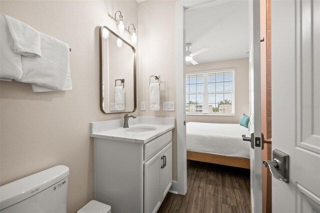 4321 Marina View Way, Cortez, FL 34215 - ensuite bathroom featuring vanity, toilet, wood finished floors, and ceiling fan