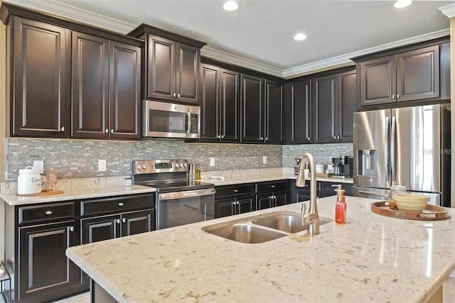 18620 Cortes Creek Blvd, Spring Hill, FL 34610 - kitchen featuring stainless steel appliances, a sink, backsplash, an island with sink, and light stone countertops