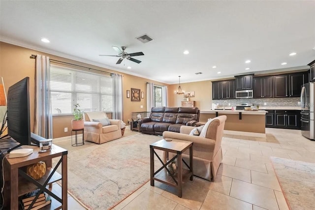 18620 Cortes Creek Blvd, Spring Hill, FL 34610 - living room featuring crown molding, recessed lighting, ceiling fan, light tile patterned floors, and a chandelier