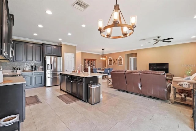 18620 Cortes Creek Blvd, Spring Hill, FL 34610 - kitchen featuring stainless steel appliances, a chandelier, light countertops, open floor plan, and a sink