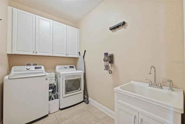 18620 Cortes Creek Blvd, Spring Hill, FL 34610 - washroom with cabinet space, independent washer and dryer, baseboards, light tile patterned flooring, and a textured ceiling