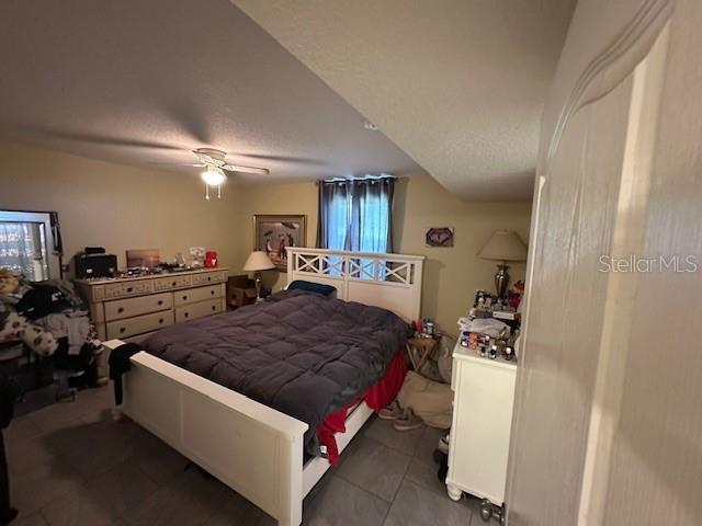 2094 Penn Dr, Deland, FL 32724 - bedroom with tile patterned floors and a ceiling fan