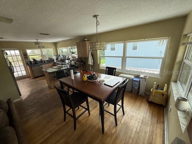 2094 Penn Dr, Deland, FL 32724 - dining space featuring hardwood / wood-style floors and a textured ceiling