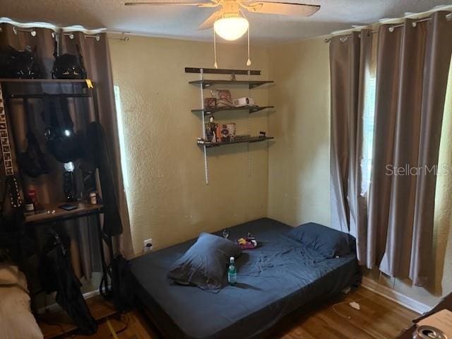 2094 Penn Dr, Deland, FL 32724 - bedroom featuring wood finished floors, baseboards, and a ceiling fan