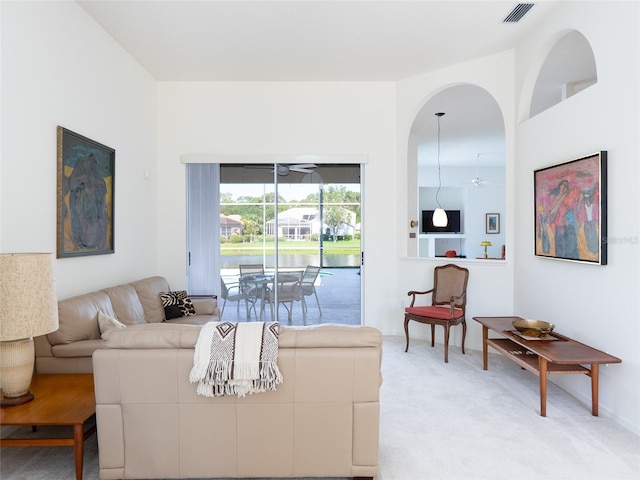4257 Hearthstone Dr, Sarasota, FL 34238 - living area with light carpet, ceiling fan, and arched walkways