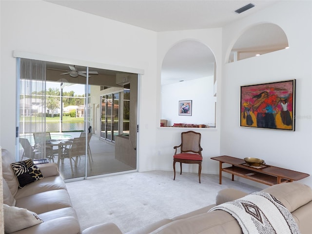 4257 Hearthstone Dr, Sarasota, FL 34238 - carpeted living area featuring a ceiling fan and arched walkways