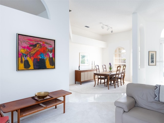 4257 Hearthstone Dr, Sarasota, FL 34238 - living area with light colored carpet, light tile patterned floors, arched walkways, and track lighting
