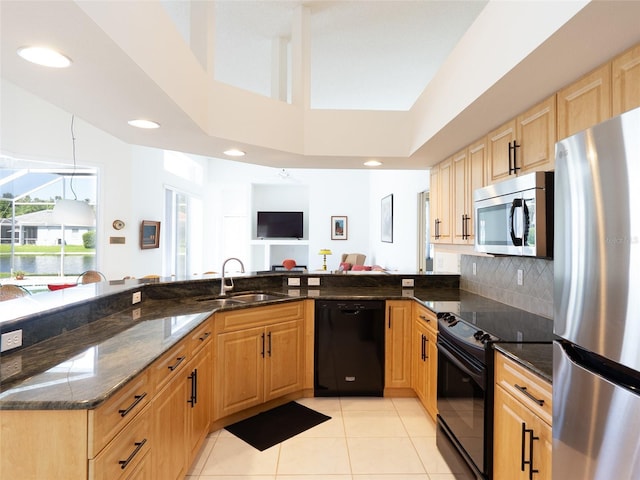 4257 Hearthstone Dr, Sarasota, FL 34238 - kitchen featuring black appliances, light tile patterned floors, dark stone countertops, decorative backsplash, and recessed lighting
