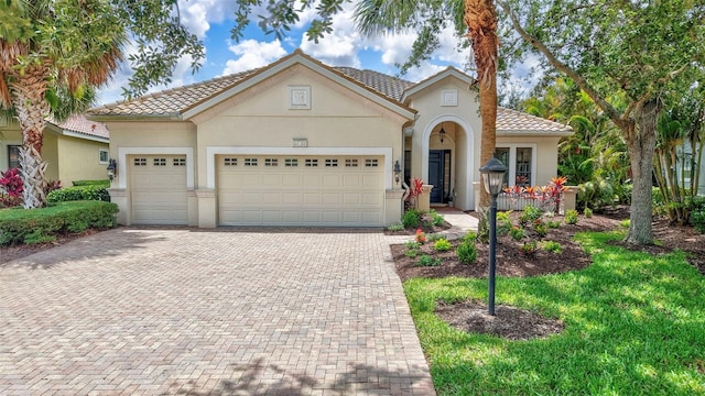 12710 Stone Ridge Pl, Lakewood Ranch, FL 34202 - view of front facade featuring stucco siding, an attached garage, decorative driveway, and a tile roof